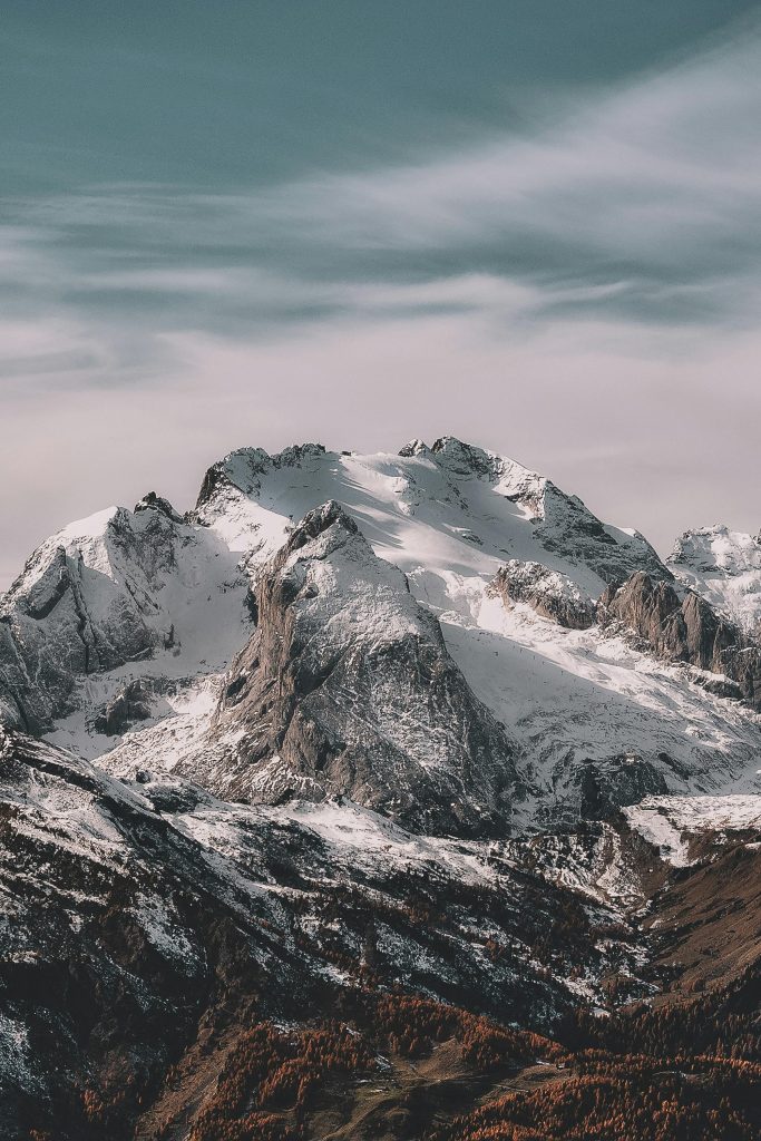 A breathtaking view of a snow-capped mountain range under a clear sky, capturing winter's beauty.