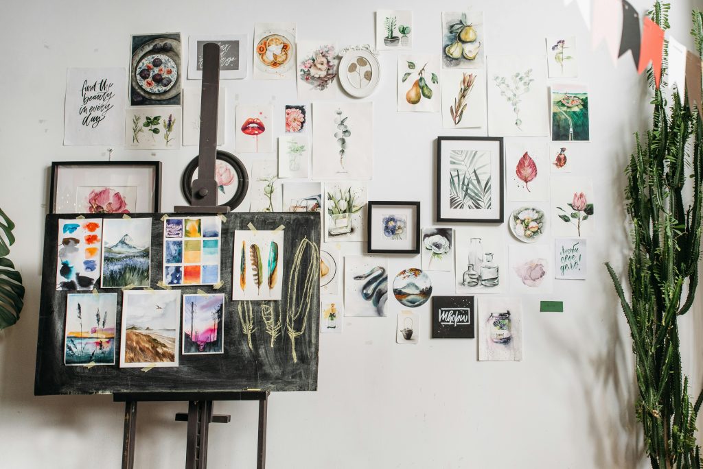 Art studio with watercolor artworks and canvas on easel, a space for creative inspiration.